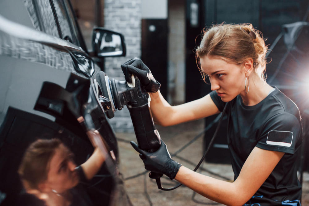 A woman polishing car surface