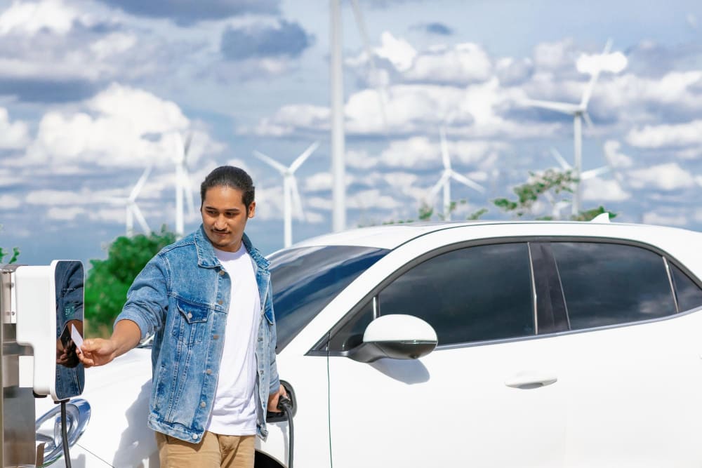 A Man Charging an EV