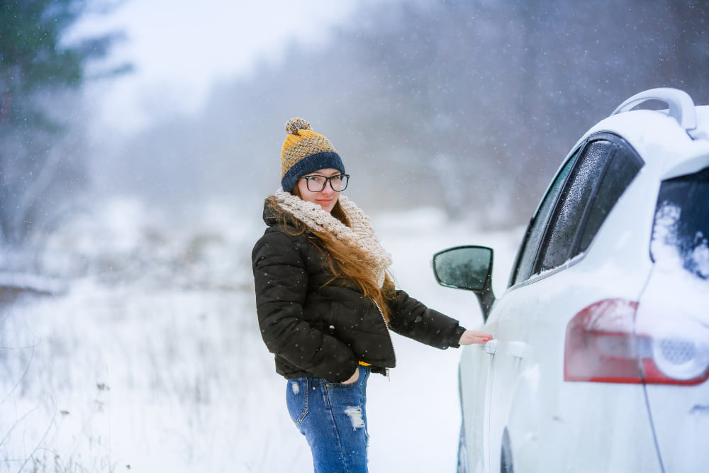 A woman beside a car